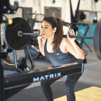 Woman lifting weights in a gym